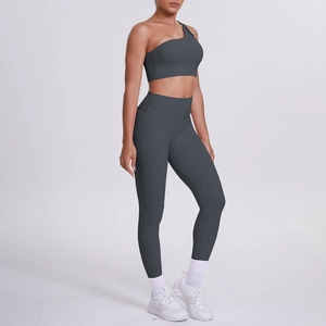Detail of dark grey one-shoulder yoga bra and high-waisted leggings set for fitness
