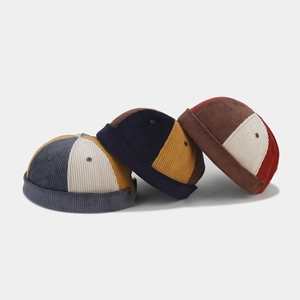 Three retro corduroy patchwork miki hats in various colors shown on a grey background