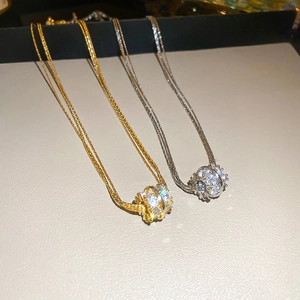 Detail of multi-layered zircon circle necklaces in gold and silver finish plating