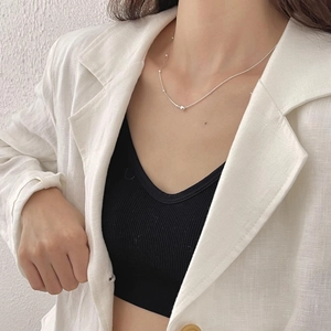 Close-up of minimalist 925 sterling silver bead chain necklace on woman's neck