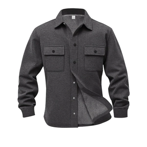 Detail of dark grey men's jacket with buttoned chest pockets and fleece lining texture