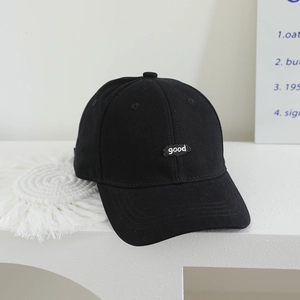 Detail of white good embroidery on black canvas baseball cap with neat stitching
