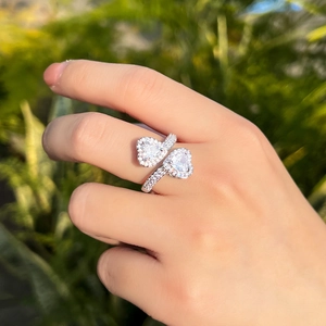 Close-up of heart-shaped zircon ring with micro-pave diamonds on silver band