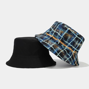 Detail of reversible sun hats showing black side and graffiti plaid pattern texture