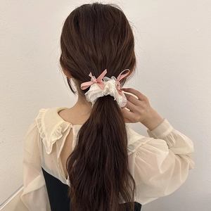 Pink ribbon bow and white mesh scrunchie for ballet-style hair styling
