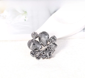 Detailed back view of fashion crystal brooch with pin fastener in gunmetal grey finish