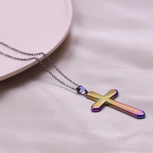 Detailed close-up of a rainbow plating cross pendant on a delicate stainless steel chain