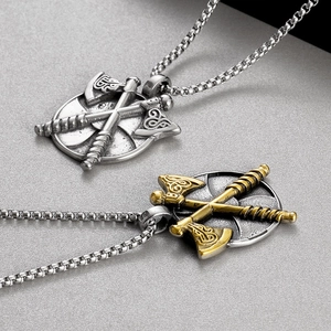 Detailed view of silver and two-tone gold Viking double axe shield pendants on box chains