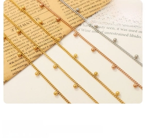 Detailed close-up of delicate beaded necklaces in gold, silver, and rose gold finishes