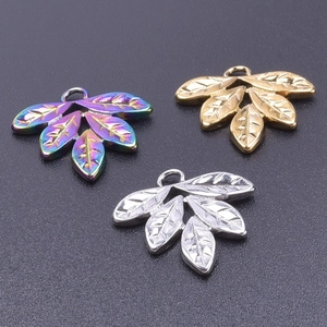 Detail of leaf-shaped stainless steel pendants in gold, silver, and rainbow finishes