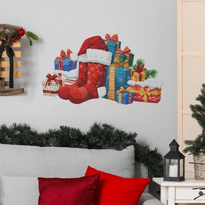 Christmas wall stickers with red stockings and gift boxes over a grey sofa home decor