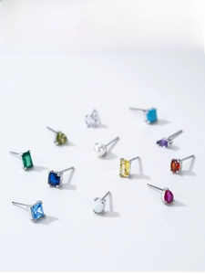 Detailed macro view of S925 sterling silver birthstone stud earrings in various colors