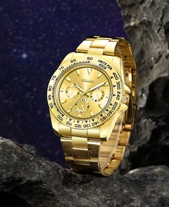 Macro shot of gold business watch with luminous hands and tachymeter bezel on rock