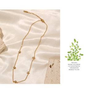 Detail of gold-plated star charms with inlaid cubic zirconia on a minimalist chain