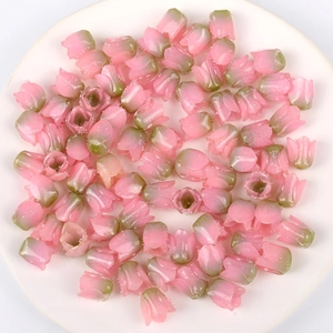Close-up of pink and green acrylic tulip flower beads for DIY jewelry making accessories