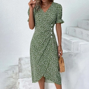 Green V-neck floral midi dress with puff sleeves and button detail on an outdoor model