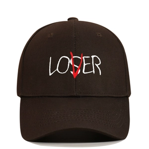 Detailed close-up of LOSER embroidery with a red V overlay on black cotton baseball cap