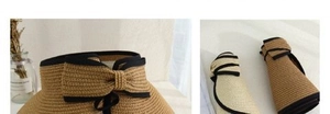 Detail of a foldable straw sun hat with contrast bow and easy storage design