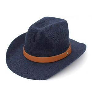 Detail of navy woven fedora hat featuring a brown leather band and gold rivet accent