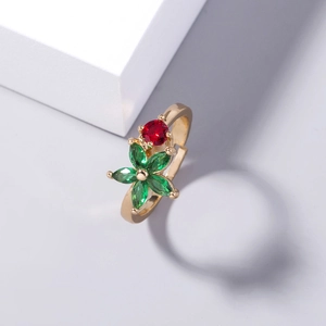 Adjustable gold flower ring with red and green crystals in a 45-degree angle view
