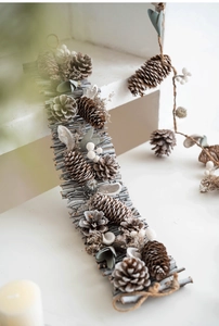 Detail of Nordic Christmas pinecone wreath with gray wood sticks and white berries