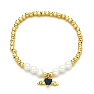 Gold beaded bracelet featuring white pearls and a blue heart zircon with wings pendant