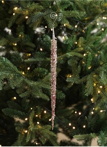 Detail of rose gold beaded icicle ornament with sequins hanging on a Christmas tree