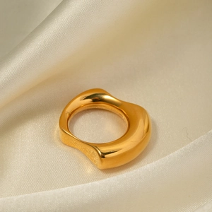 Detail of 18k gold plated stainless steel irregular ring on beige silk background