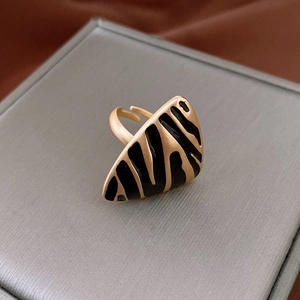 Detailed macro view of French vintage gold zebra pattern ring with matte finish texture