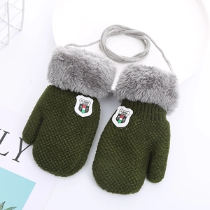 Detail of green knitted kids mittens with gray plush cuffs and neck string cord