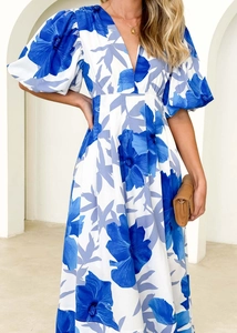 Close-up of blue and white floral print dress with puff sleeves and elegant V-neckline