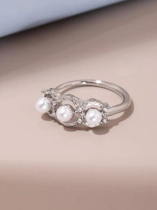 Detail of silver steel ring with three pearls and hexagon zirconia pave setting