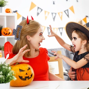 Square Halloween hair claw with skull print worn by a woman in a festive party setting