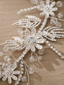 Detailed view of silver bridal headband with sparkling rhinestones, crystals and pearls