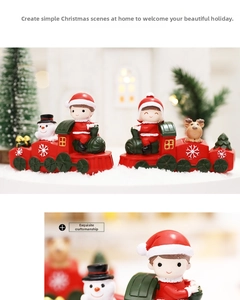Close-up of resin Christmas train ornaments with Santa and reindeer on warm backgrounds