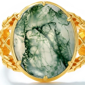 Macro shot of oval green moss agate stone with intricate leaf patterns on golden ring band