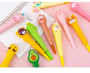 Close-up of cute cartoon squishy pens featuring unicorn and pig toppers for stress relief