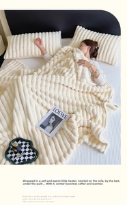Close-up of cream faux rabbit fur blanket featuring 3D striped texture and embossed grain