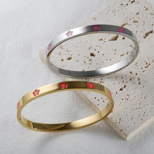 Minimalist stainless steel flower bangles in gold and silver with pink enamel floral patterns