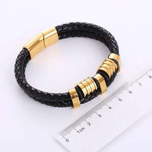 Detail shot of black braided leather bracelet for men with golden magnetic clasp and ruler