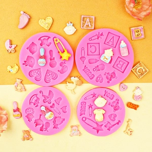 Pink silicone baby shower molds featuring strollers and bottles for fondant cake decorating