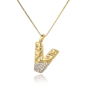 Macro detail of V-shaped gold necklace pendant with paved white cubic zirconia