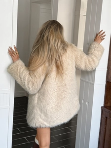 Rear view of an elegant beige faux fur coat for women with a soft plush texture