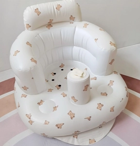 Close-up of PVC inflatable baby chair featuring a brown bear print and built-in pump