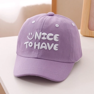 Detail of lavender cotton baseball cap with white smiley face and NICE TO HAVE embroidery