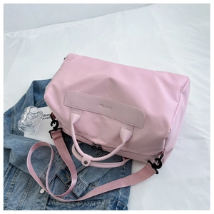 Pink waterproof travel bag with large capacity, featuring detachable strap and HFTY BAG logo