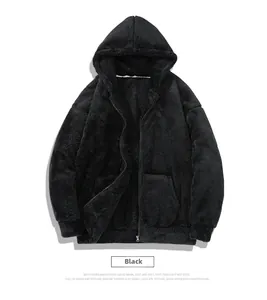Detail of reversible black fleece hoodie showing plush texture and ribbed cuffs