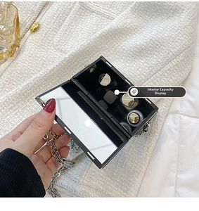 Detail of crossbody phone bag showing inner capacity, makeup mirror and chain strap