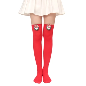 Detail of red over-knee Christmas socks with mini wreath and festive bow decoration