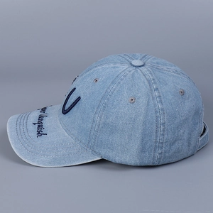 Detail of light blue denim baseball cap with Vanquish embroidery and vintage texture